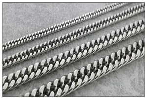 Close-up detail of wide titanium steel curb chains, double-woven polished men necklace links.