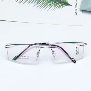 Detail shot of lightweight rimless optical glasses frames with square demo lenses and metal temples.