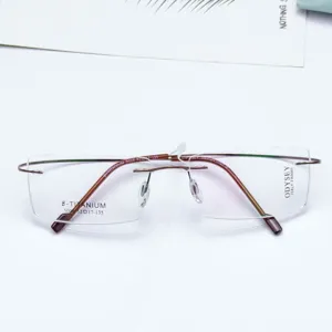 Minimalist square rimless eyeglasses frame with brown titanium temples and clear demo lenses.