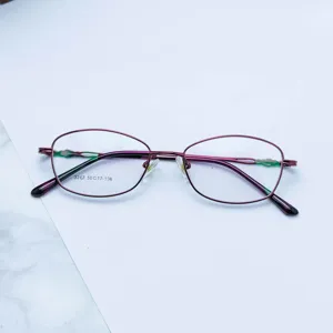 Close-up detail view of the women's metal optical frame glasses in elegant purple red finish.
