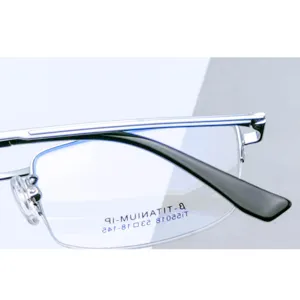 Close-up detail of men business half-frame titanium eyeglasses frame with demo lens specs.