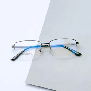 Detailed shot of men's business half-frame titanium eyeglasses with clear blue light lenses.