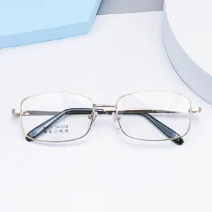 Detail view of square metal eyeglass frames with thick gold plating and temple tips.
