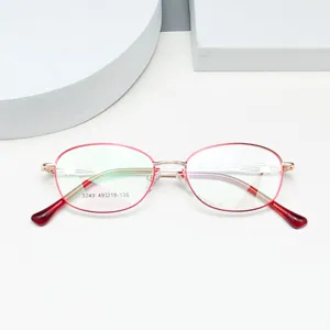 Lightweight red and gold oval metal optical glasses frame for women daily business wear.