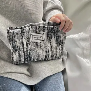 Black and white textured cosmetic bag, vintage literary style portable hand pouch for daily use.
