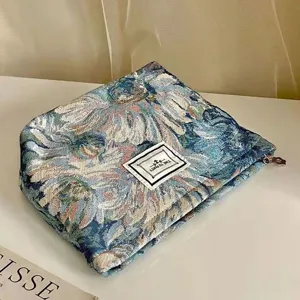 Vintage floral tapestry makeup pouch detail showing woven fabric and neat zipper closure.