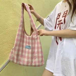 Detailed view of the pink checkered canvas tote bag showcasing its lazy style and shoulder strap.