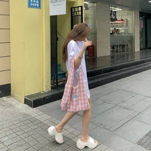 Detailed shot of a Korean style pink plaid plush shoulder bag in outdoor street setting.