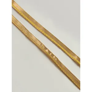 Detailed shot of shiny gold cross leg straps featuring neat decorative yellow stitching.