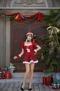 Detailed shot of women Christmas cosplay costume featuring red polka dot design and fluffy trims.