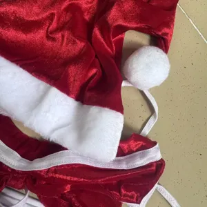 Close-up detail of sexy red velvet Christmas lingerie set with plush white trim and straps.