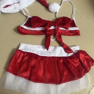 Detailed view of Christmas lingerie set, featuring red velvet, white trim and hat.