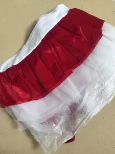 Christmas costume detail view showing red velvet and white tutu mesh layers in packaging.