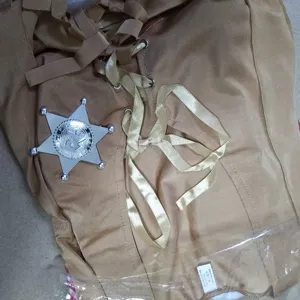 Western cowboy costume detail view showing corset lacing and sheriff badge accessory.