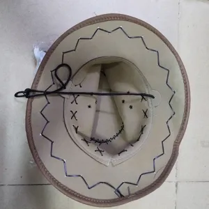 Western cowboy hat with brown brim, black chin cord and decorative zigzag stitching detail.