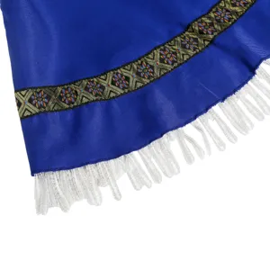Blue costume fabric hem detail featuring traditional woven trim and white loop fringe border.