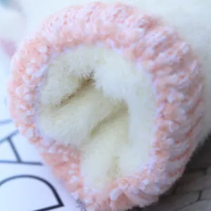 Cozy winter fleece gloves close-up, soft knitted warm half-finger mittens for women.