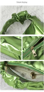Detailansicht der metallisch grünen Handtasche mit Reißverschluss und praktischem Griff.