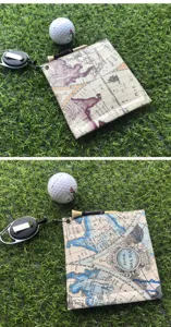 Retro map print golf towel with retractable clip and golf ball, premium sports accessory.