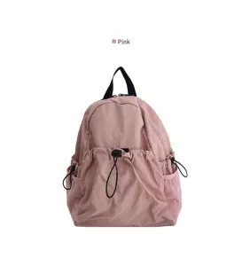 Rosa Kordelrucksack Detailansicht mit Fronttasche und Mesh-Seitenfächern für Alltag.