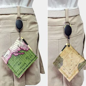 Golf ball cleaning towel with vintage map pattern, retractable clip for easy bag or belt attachment.