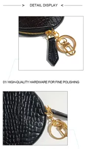 Detailed view of the black crocodile pattern coin purse with gold hardware and zipper.