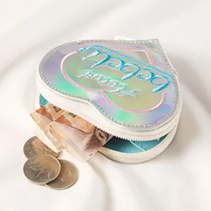 Close up detail of heart-shaped laser coin purse, holographic texture and zipper.