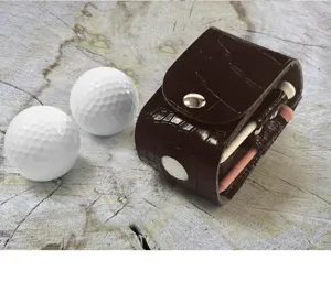Crocodile texture leather golf ball holder detail, portable golf pouch and tees display close up.