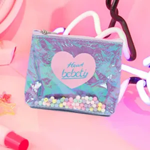 Close-up of holographic PVC coin pouch detail, transparent shaker window with colorful beads.