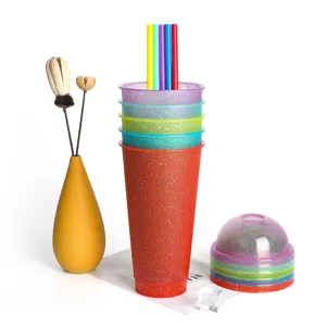 Colorful plastic glitter cold cups with dome lids and reusable straws, ideal for drinks.