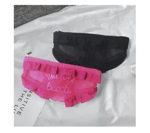 Detail shot of cute underwear shaped mesh cosmetic pouches in black and pink with ruffles.