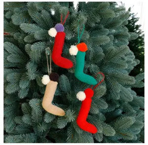 Detailed view of handmade knitted Christmas tree hanging stockings, festive holiday decor.
