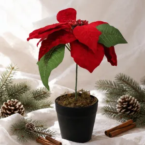 Artificial poinsettia Christmas flower potted plant with black pot for holiday decor.