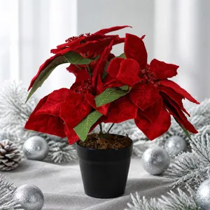Detailed view of artificial red velvet poinsettia in black pot with festive christmas decor.