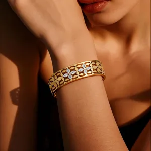 Stainless steel wide cuff bracelet with clover cutout design and sparkling crystals for women.