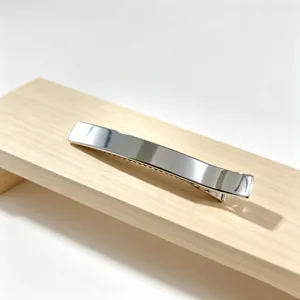 Silver metallic hair clip detail shot, elegant minimalist design, large duckbill barrette.