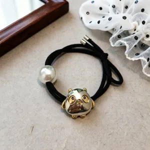 Close-up detail of black elastic hair tie featuring a pearl and metallic animal charm.