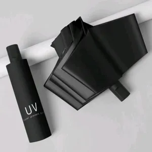 Compact black folding sun umbrella with capsule case, UV protection for daily outdoor travel.