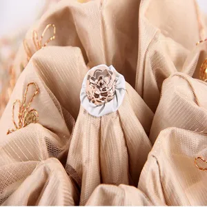 Close-up detail of double-layer pleated lace umbrella interior with delicate floral embroidery accent.