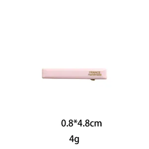 Pink rectangular hair clip detail close-up, elegant minimalist side hairpin, lightweight design.