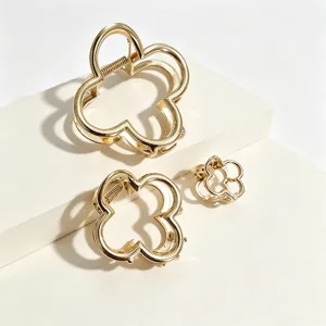 Gold hollow clover hair claw detail view, elegant metal hairpin set for women updo styling.