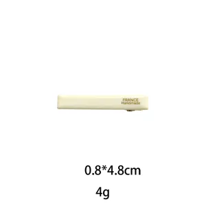 Detailed closeup of the minimalist cream rectangular hair clip, 0.8x4.8cm compact size accessory.