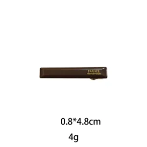 Brown rectangular hair clip detail view, glossy finish with French handmade style design.