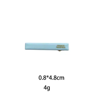 Detailed view of the elegant light blue barrette showing its smooth surface and compact size.