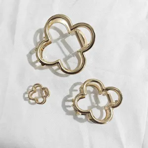 Detail shot of gold metal flower claw clips set, hollow design for chic and stylish hair.