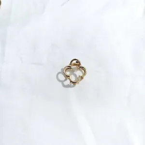 Detail shot of a mini gold alloy four leaf clover hair claw clip showcasing fine design.