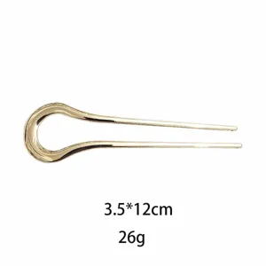 Elegant gold alloy U-shaped hair fork, minimalist curved hair stick for women styling.