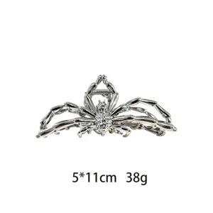 Detailed close-up view of silver metal spider hair claw clip, gothic style hair accessory.