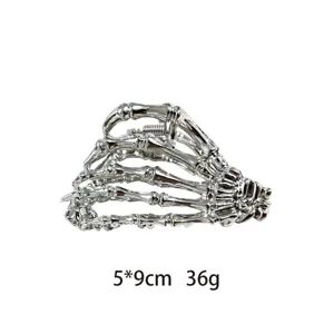 Metal skeleton hand hair claw clip detail, gothic style silver hair accessory close-up view