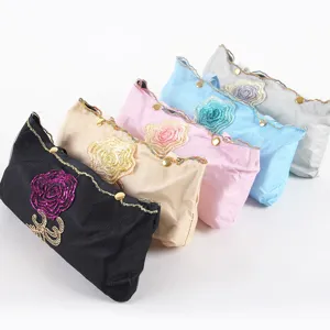 Compact folding sun umbrella with delicate embroidered rose flower design and elegant gold buttons.